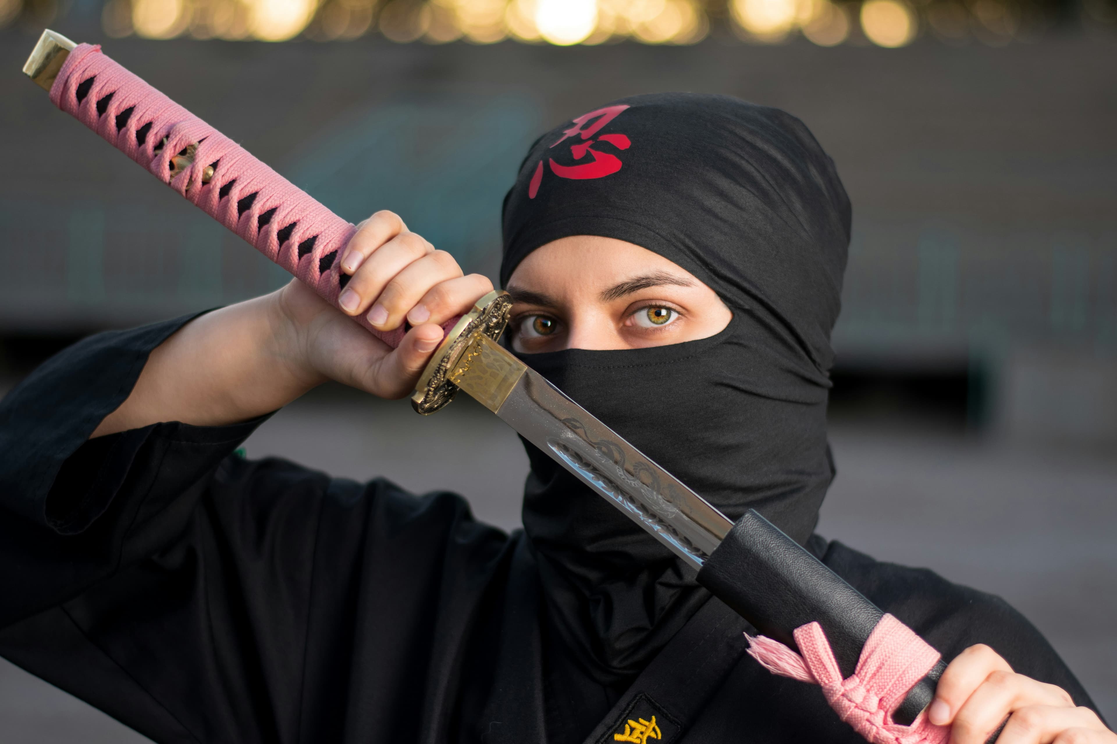 Guest in ninja costume throwing a shuriken at a wooden target
