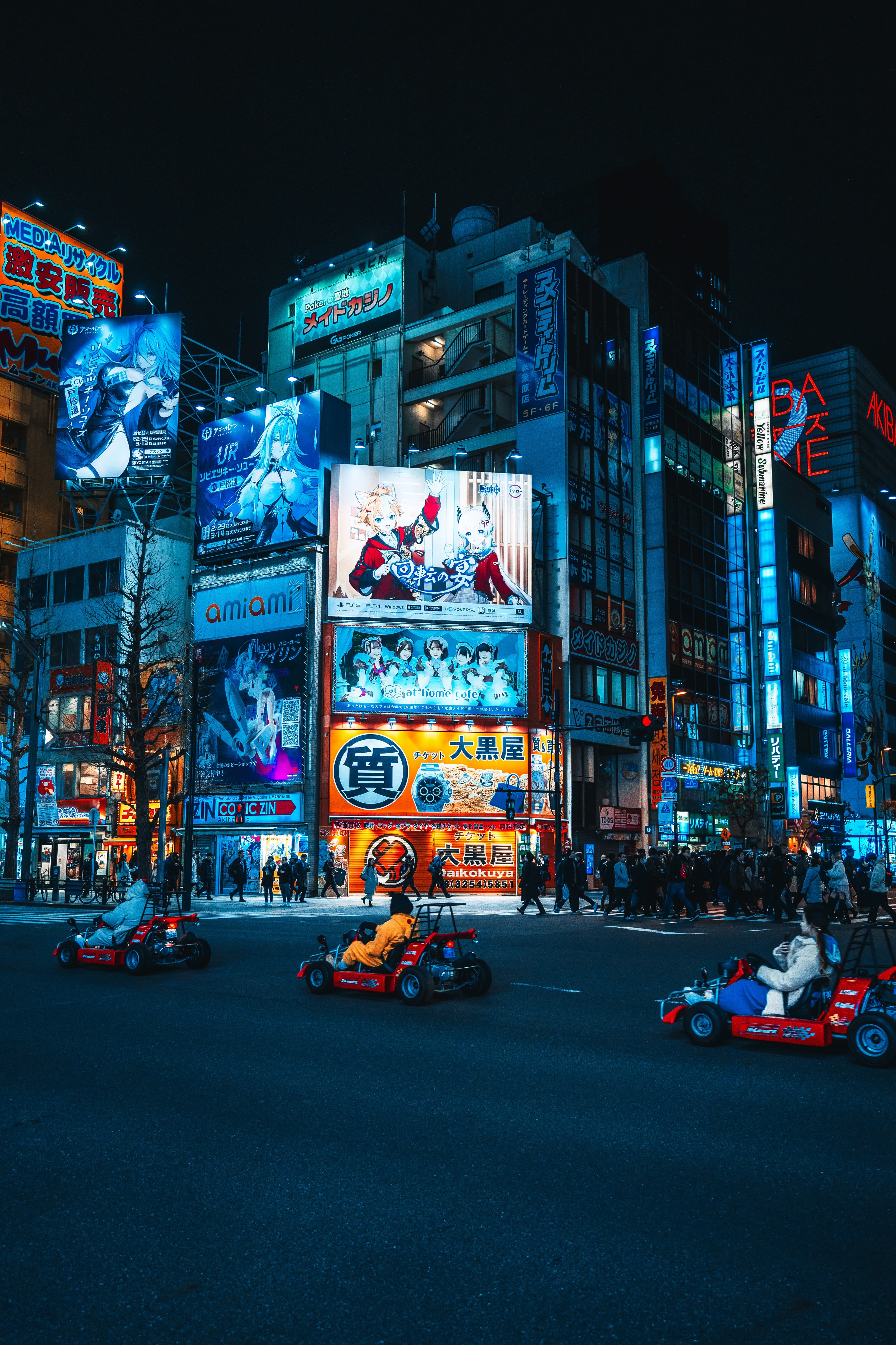 Go-kart convoy crossing a Tokyo intersection in costume
