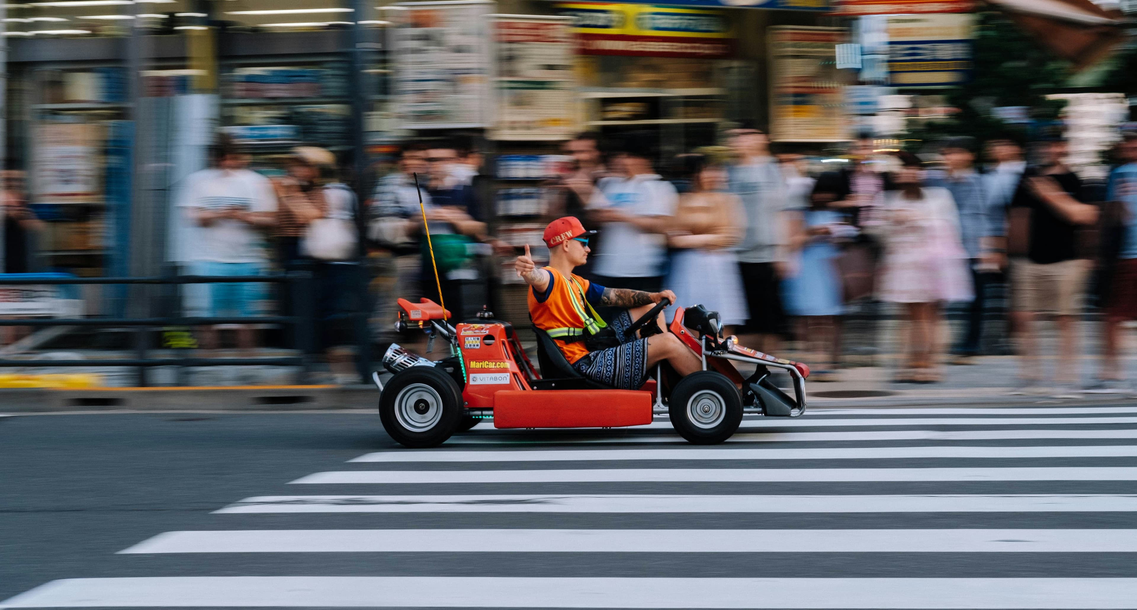 Kart convoy racing through a Tokyo street